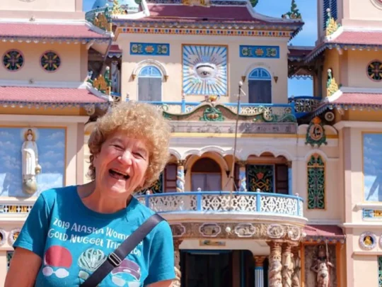 Tourist in front of colorful Ba Den Mountain temple, Tay Ninh, Vietnam