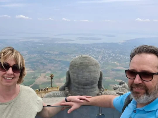 Couple at Buddha statue viewpoint on Ba Den Mountain, Tay Ninh