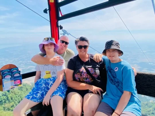 Tourists riding Ba Den Mountain cable car with scenic views, Tay Ninh