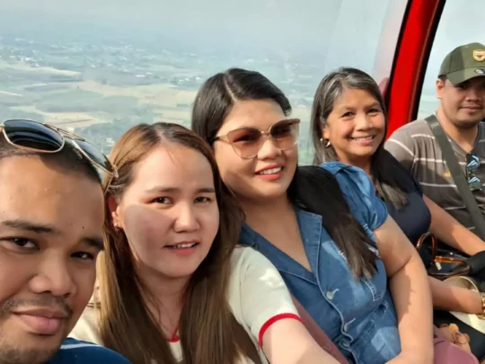 Tourists taking group selfies at Ba Den Mountain, Tay Ninh, Vietnam