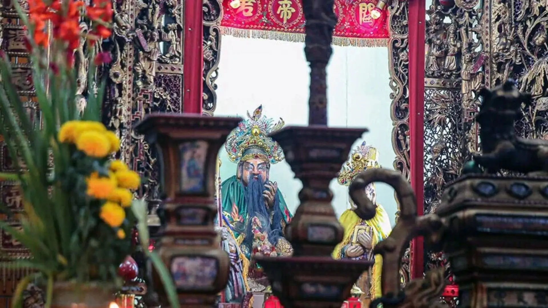 Offering table with flowers inside Ong Temple