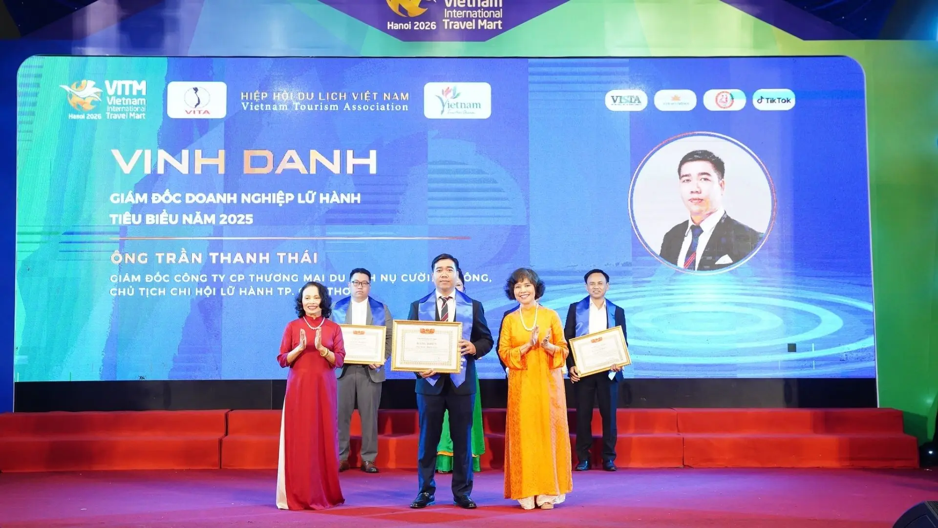 Mekong Smile leadership receiving official recognition on the main stage of the VITM Hanoi 2026 event