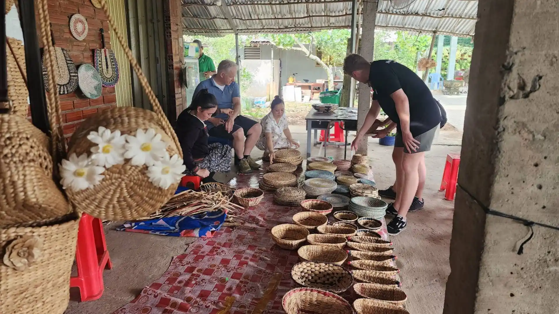 A display of various handcrafted wicker baskets and woven goods at a local workshop on Tan Phong Islet with Mekong Smile