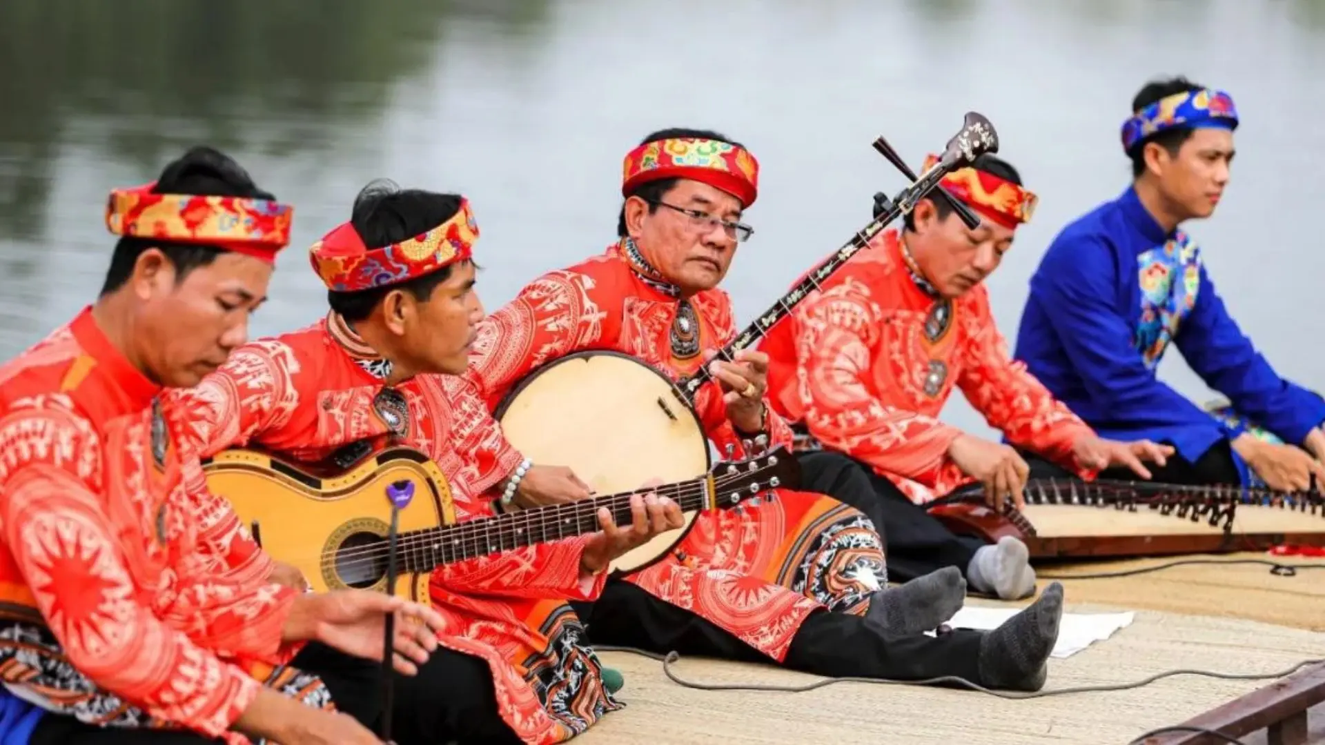 Tan Phong Islet: Cai Be’s Rambutan Kingdom & Eco-Paradise 166 A group of Vietnamese musicians in traditional red outfits playing string instruments on Tan Phong Islet