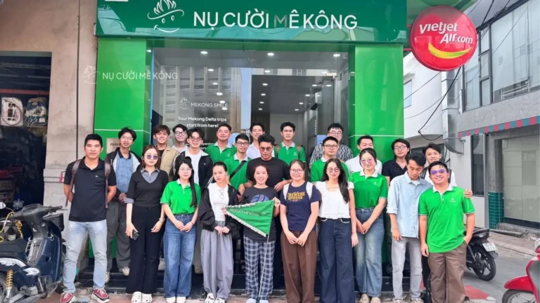Mekong Smile team members and event participants gather for a group photo outside the company office.