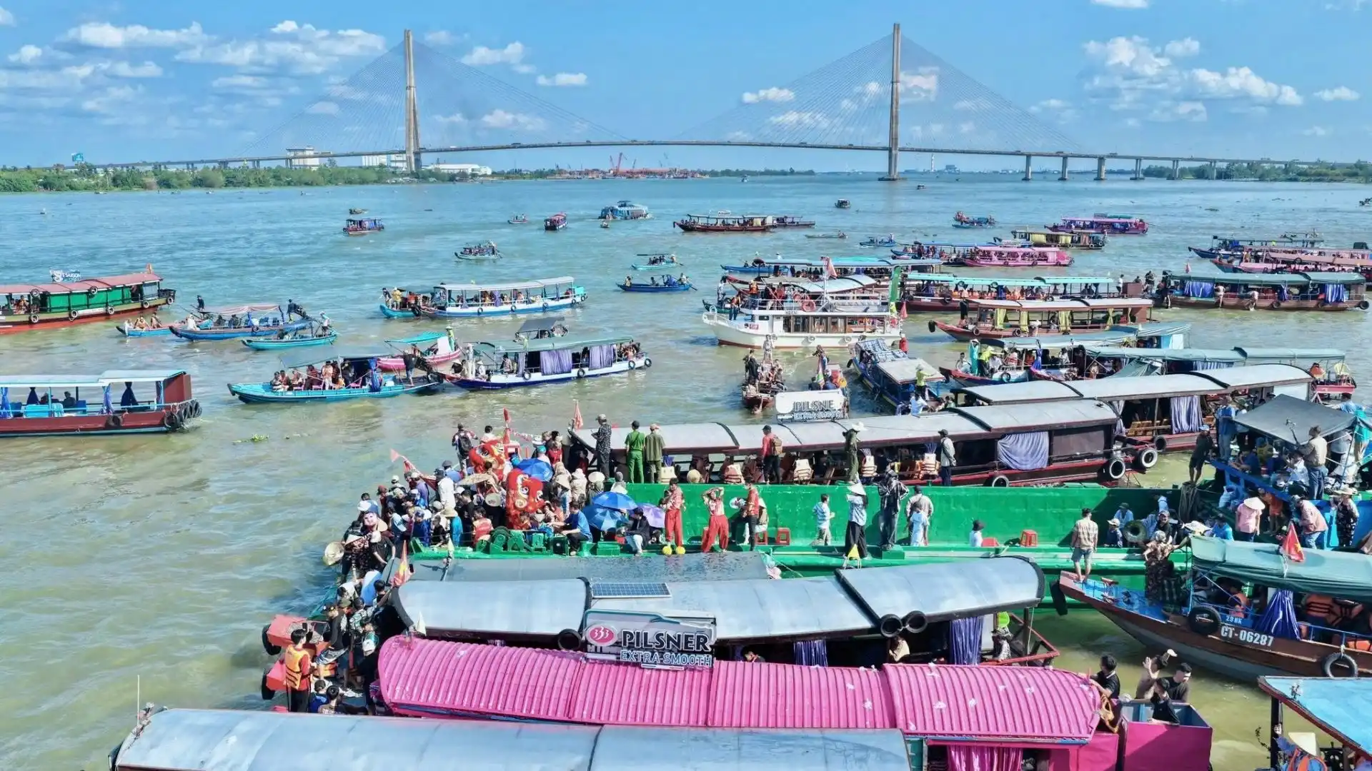 Large gathering of boats and participants celebrating Tong Phong Festival on the river in Can Tho