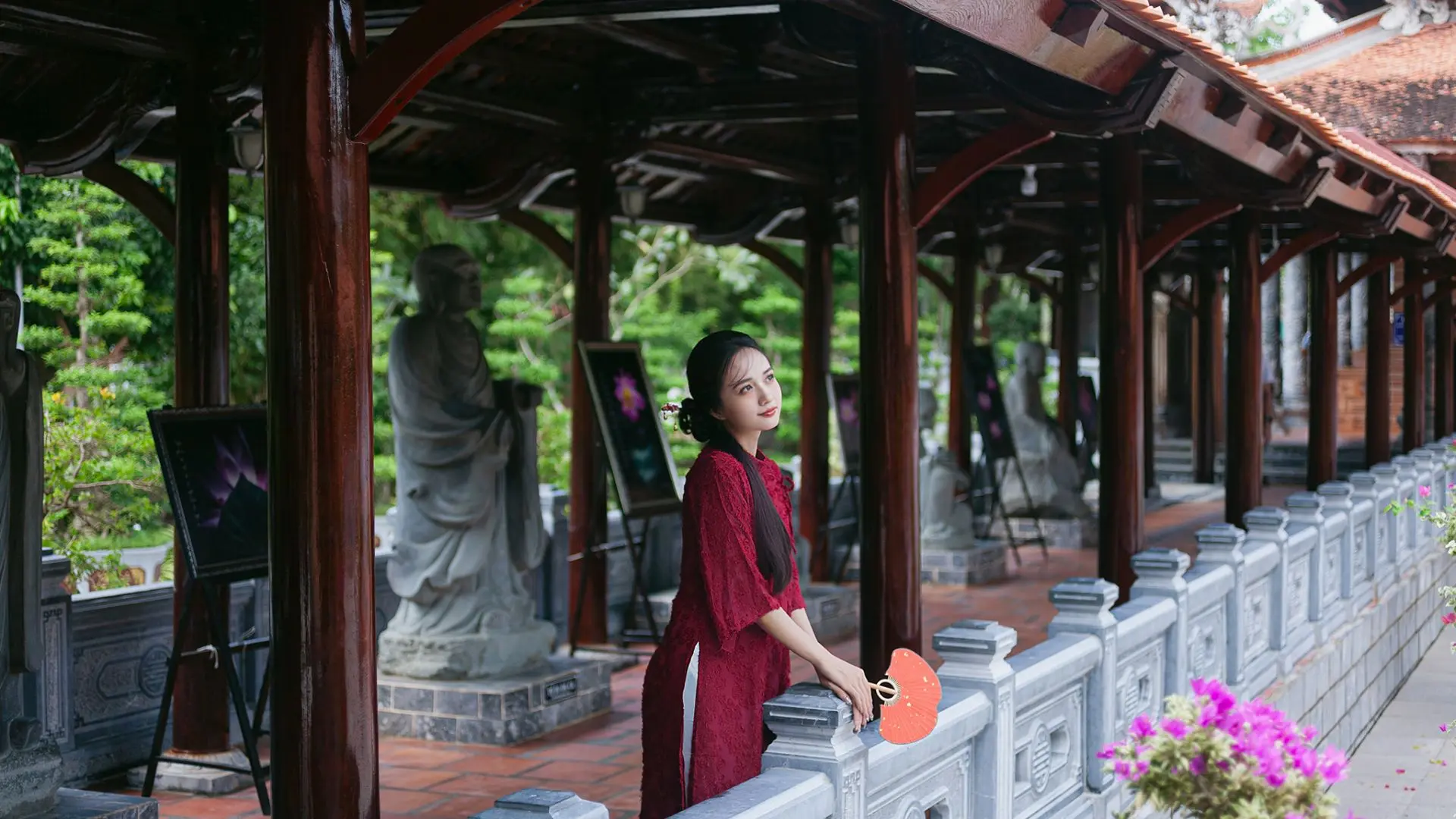Tourists take photos in the tiled-roofed monastery corridor.