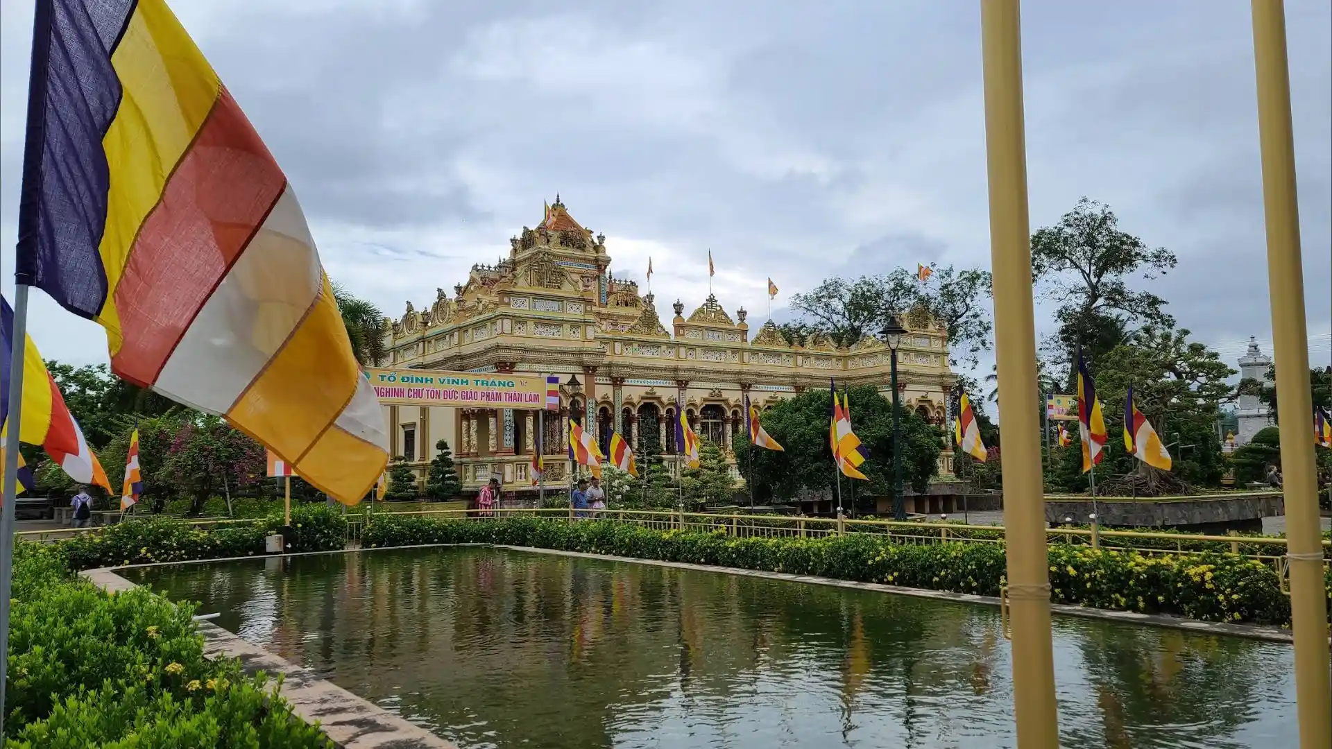 Buddhist flags and temple view at Vinh Trang Pagoda in My Tho, Tien Giang