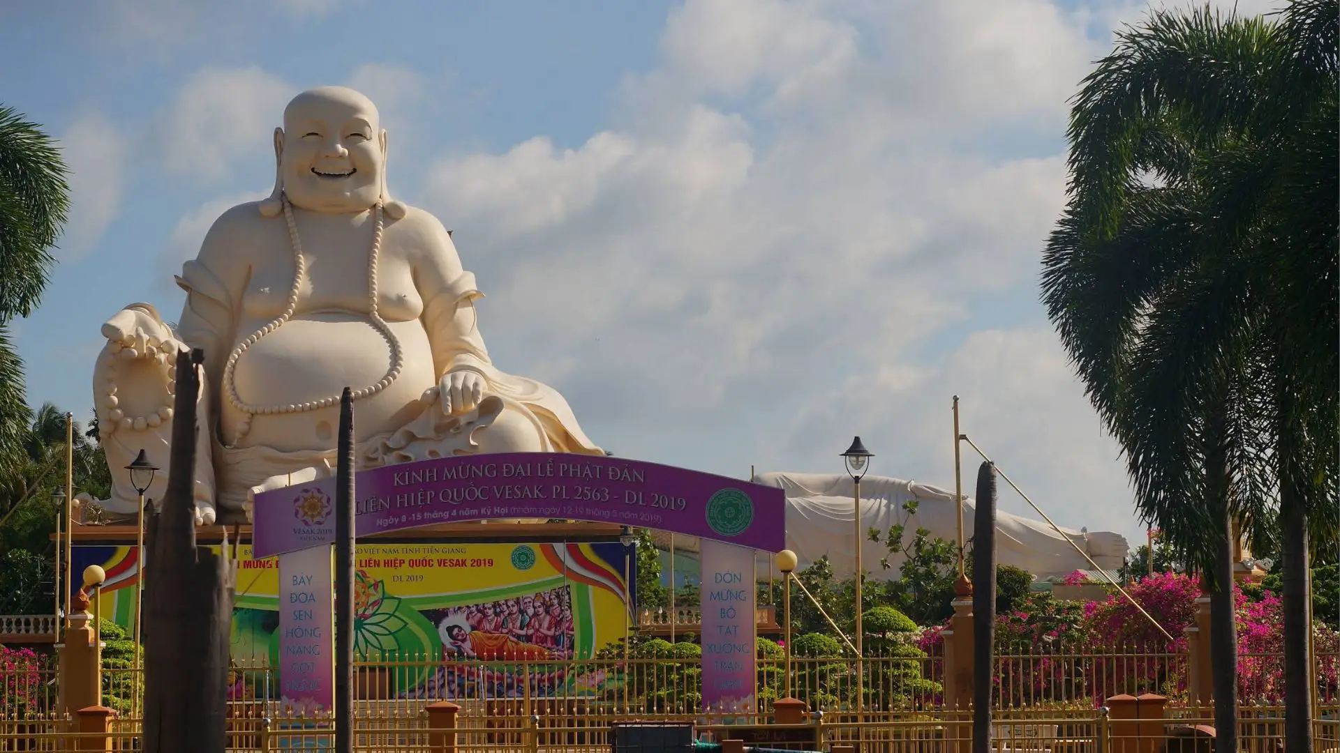Laughing Buddha statue at Vinh Trang Pagoda, a popular attraction in Tien Giang
