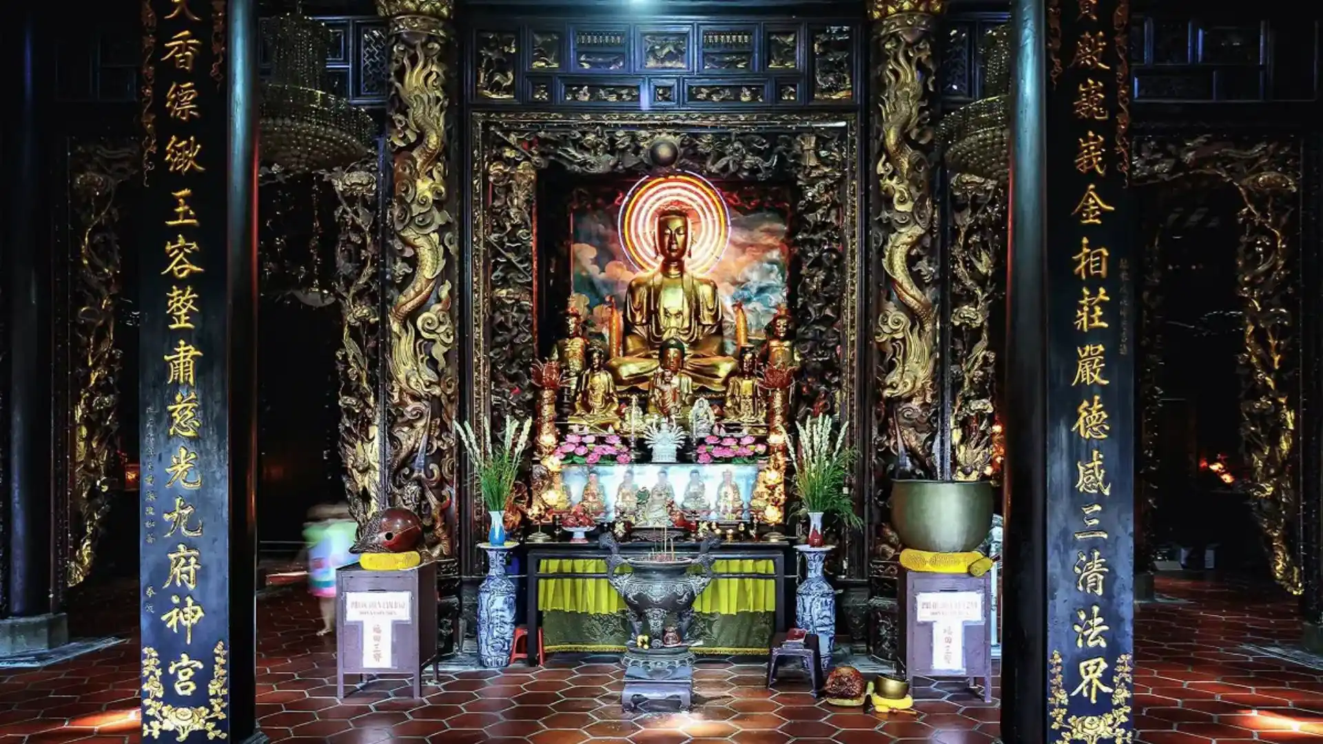 Ornate Buddhist altar inside the main hall of Vinh Trang Pagoda in Tien Giang, Vietnam