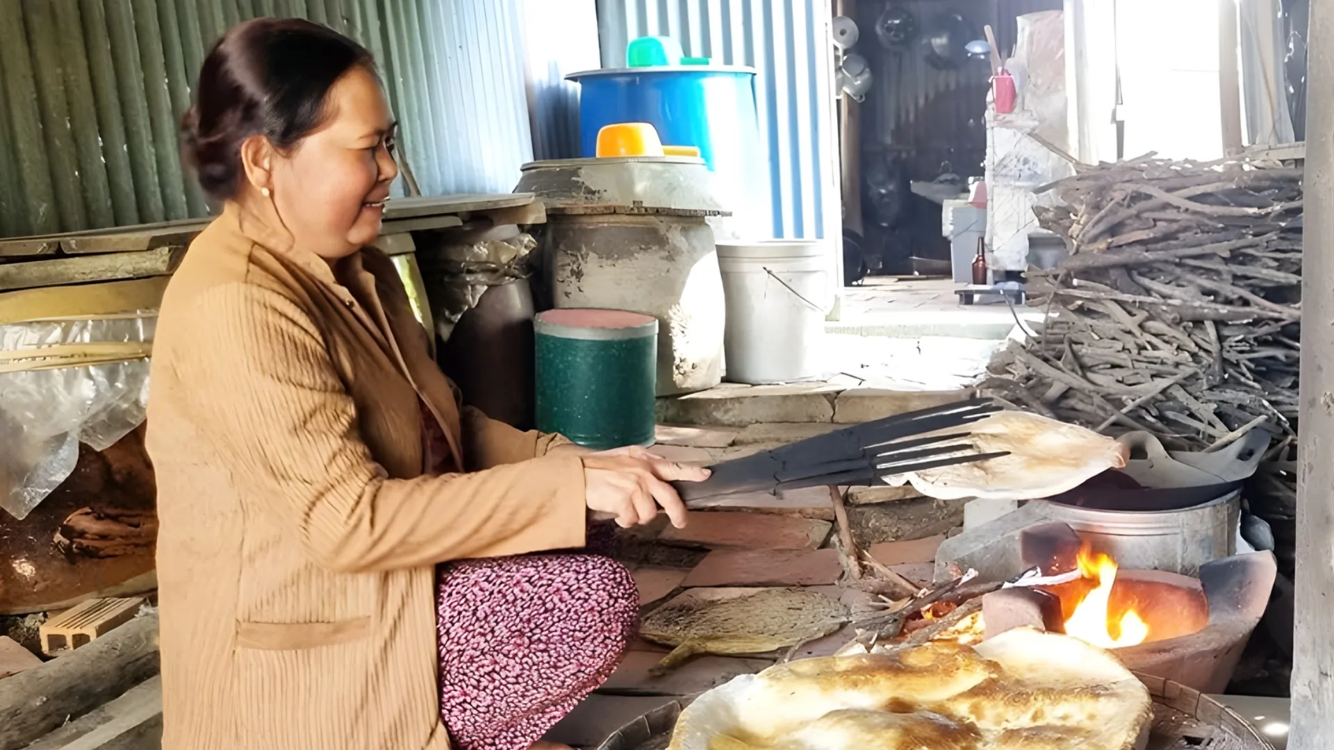 Son Doc Puff Rice Paper Village: Ben Tre’s Coconut Craft Heritage 161 Aoman roasting puff rice paper over a charcoal stove until puffed and crispy