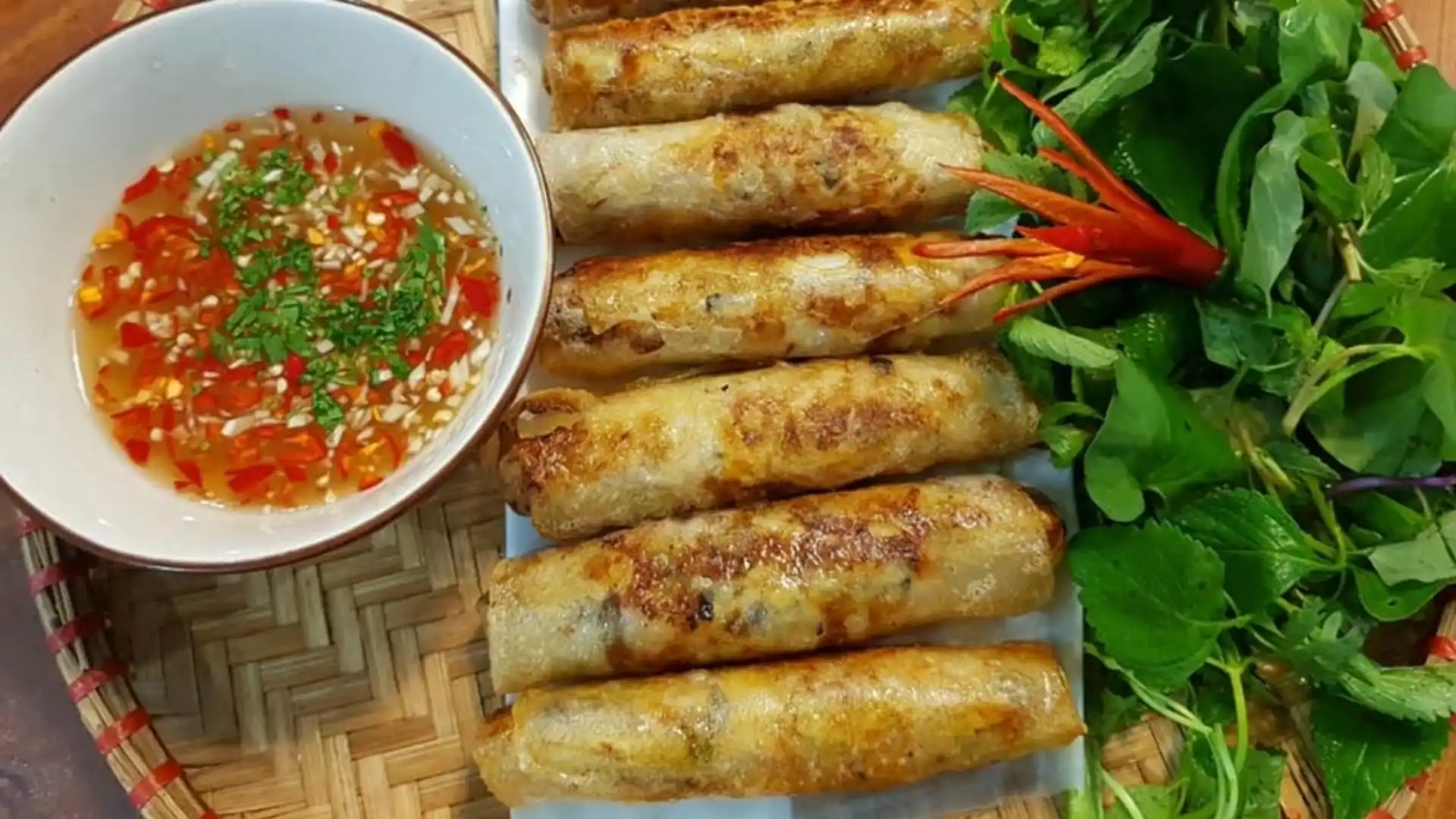 What to Eat in Vietnam: 30 Must-Try Dishes 76 Golden Vietnamese fried spring rolls served with herbs and dipping sauce