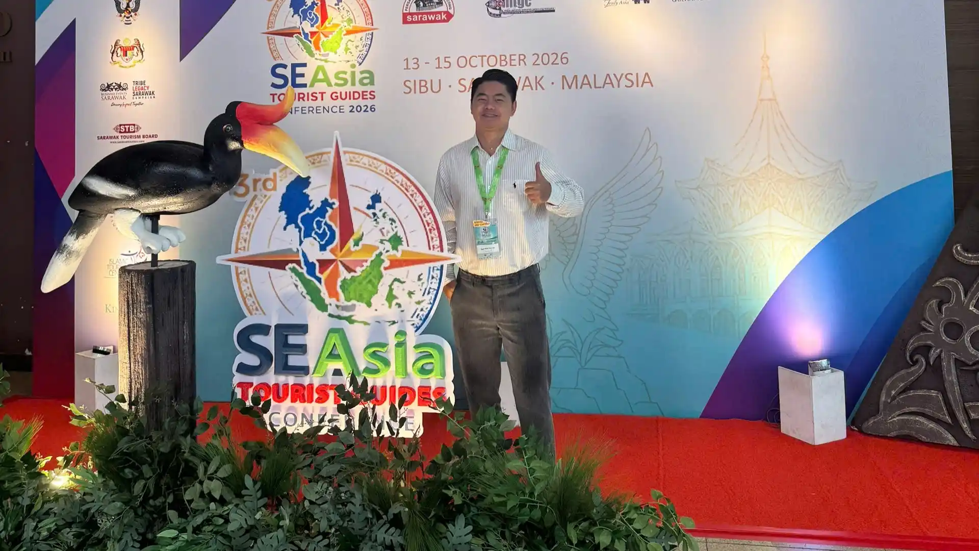 Mekong Smile Joins the 3rd Southeast Asian Tourist Guides Conference 2026 12 Ngô Minh Đức Uy (Jimmy) posing beside the official backdrop of the 3rd Southeast Asian Tourist Guides Conference 2026 in Sibu.