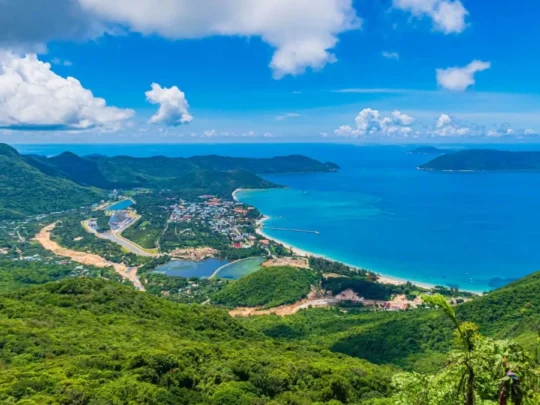 Panoramic Con Dao National Park view during Ong Cau Beach tour with forest mountains and blue coastline
