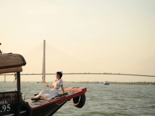 Tourists taking photos with Can Tho Bridge at sunset – Can Tho Sunset Tour with Mekong Smile