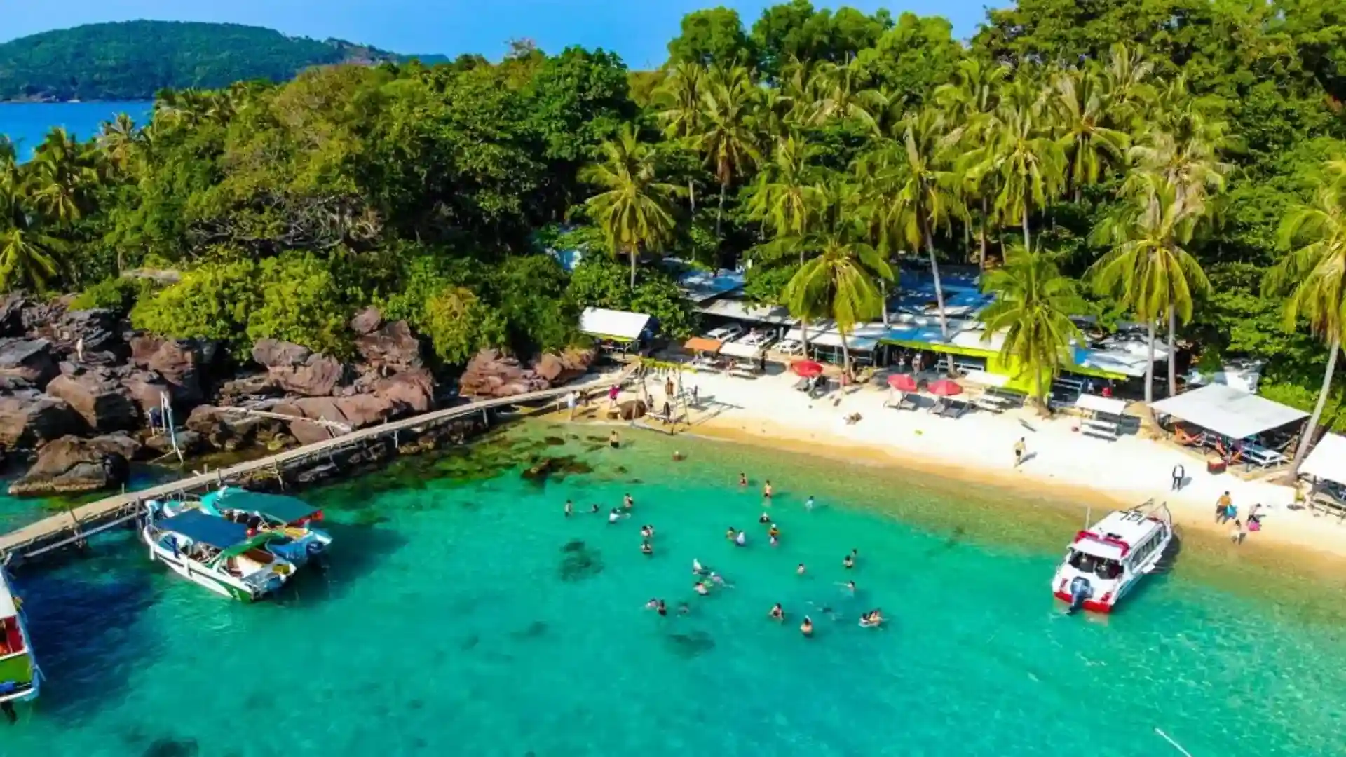 Vietnam Travel Guide for First-Time Visitors 24 Aerial view of a tropical beach with turquoise water and boats in Phu Quoc