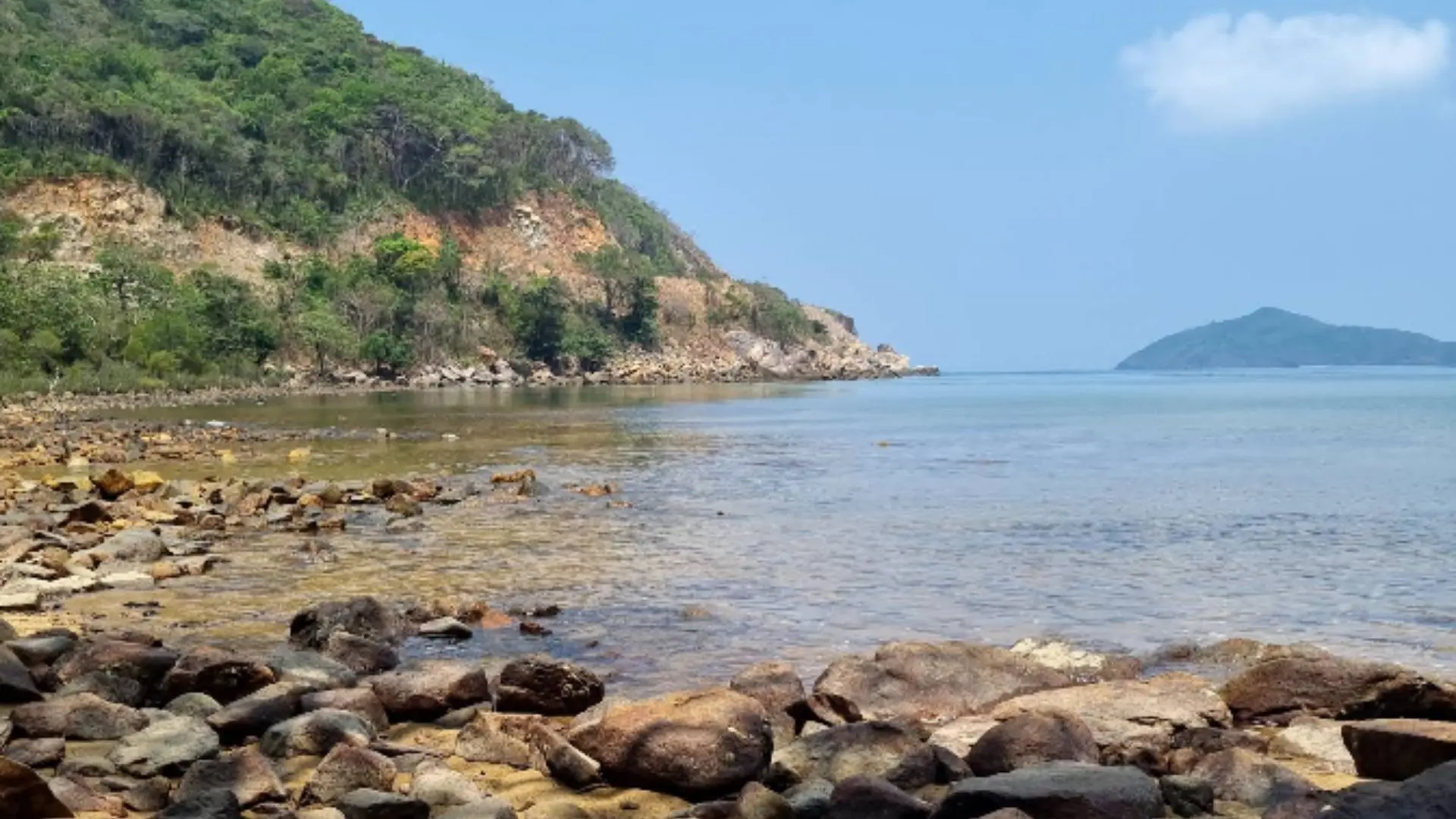 Rocky shoreline and tropical coastal landscape during Ong Cau Beach tour in Con Dao