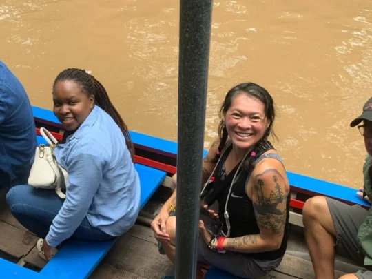 Rowing boat through narrow canals lined with water coconut trees in My Tho