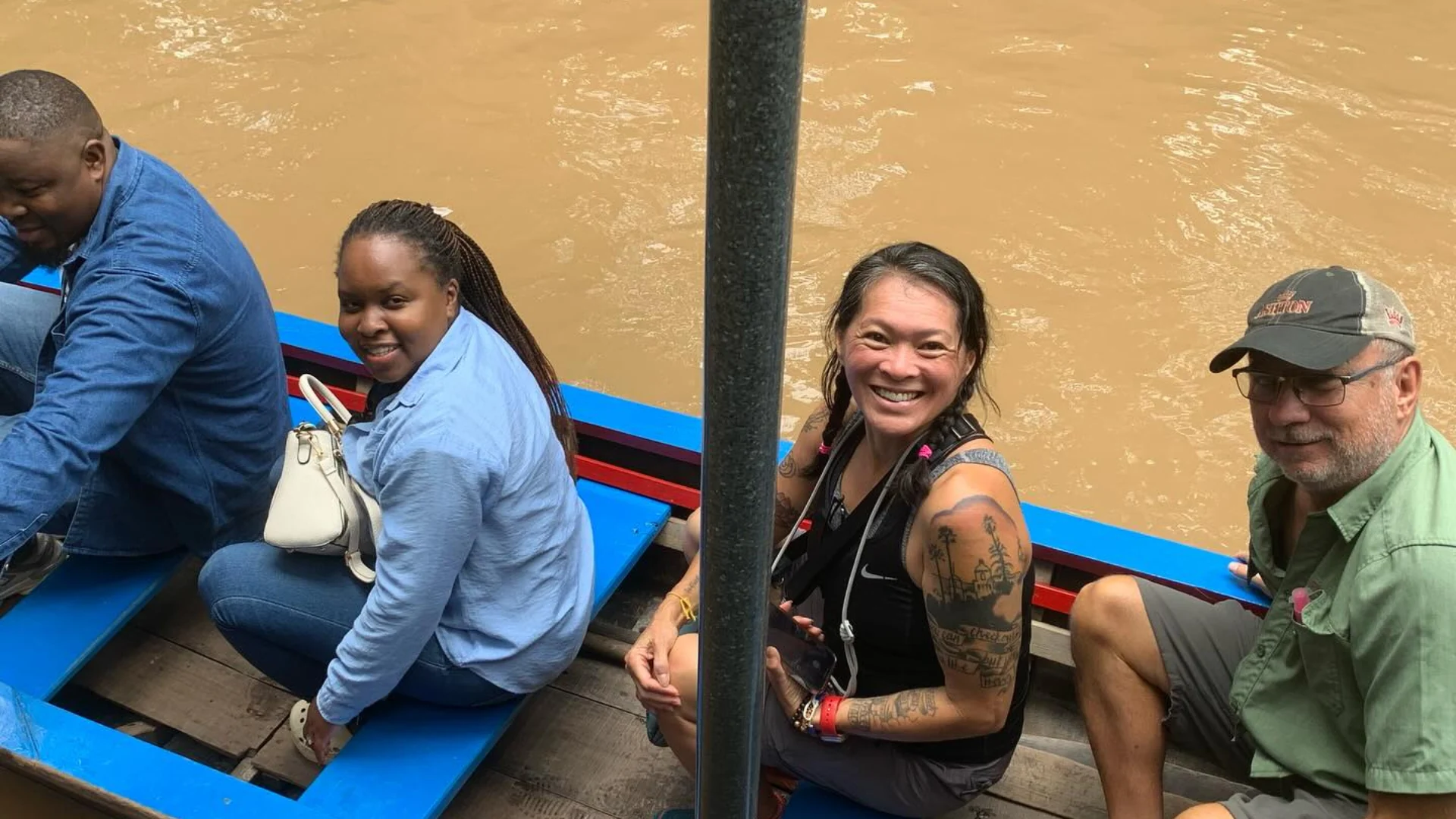 Rowing boat through narrow canals lined with water coconut trees in My Tho
