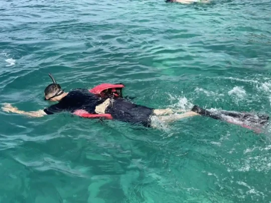 Snorkeler exploring the shallow waters of Bamboo Lagoon in Con Dao