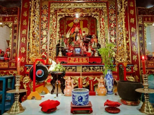 The traditional interior design of Binh Thuy Ancient Temple, showcasing intricate carvings and Vietnamese cultural heritage.