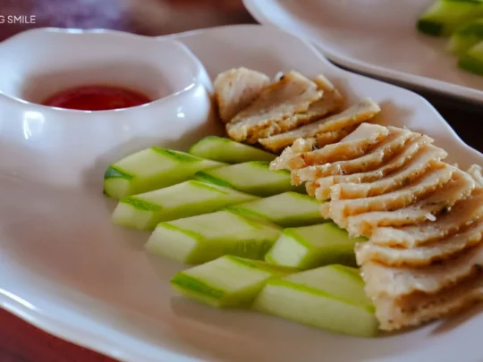 A group of people enjoying delicious fish cake served directly on a floating fish raft.