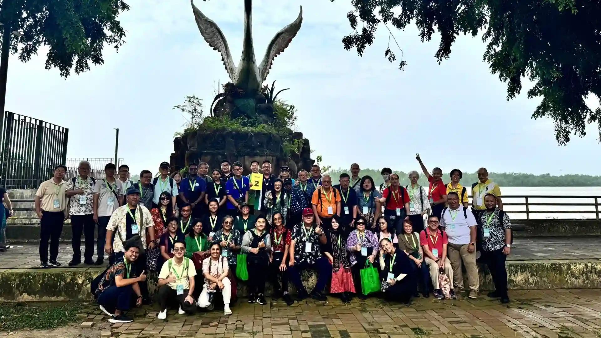 Mekong Smile Joins the 3rd Southeast Asian Tourist Guides Conference 2026 14 Group photo beside a large bird sculpture near the riverfront during a cultural outing in Sarawak, Malaysia.