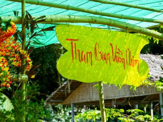 The entrance gate to a lush bird sanctuary, marking the start of a Southern Forest tour