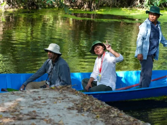 A local guide smiling happily, reflecting the joy and satisfaction of the tour experience
