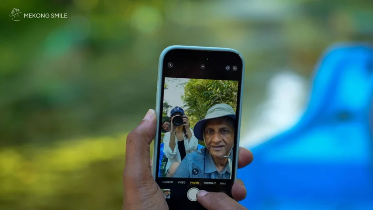 A tourist happily posing for a photo with the beautiful forest scenery