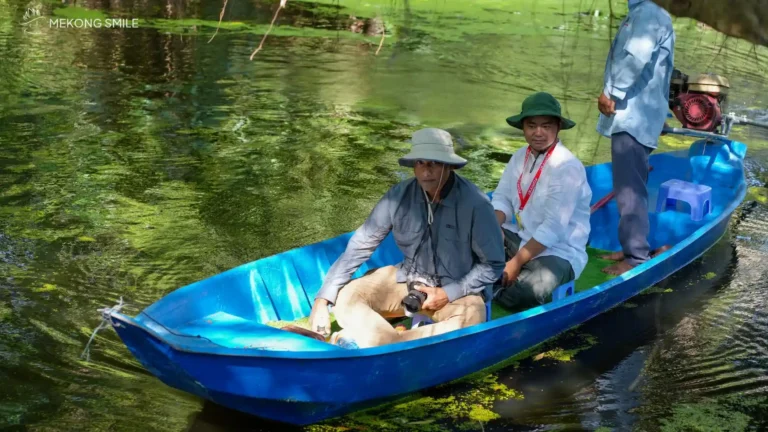 A tourist happily posing for a photo with the beautiful forest scenery