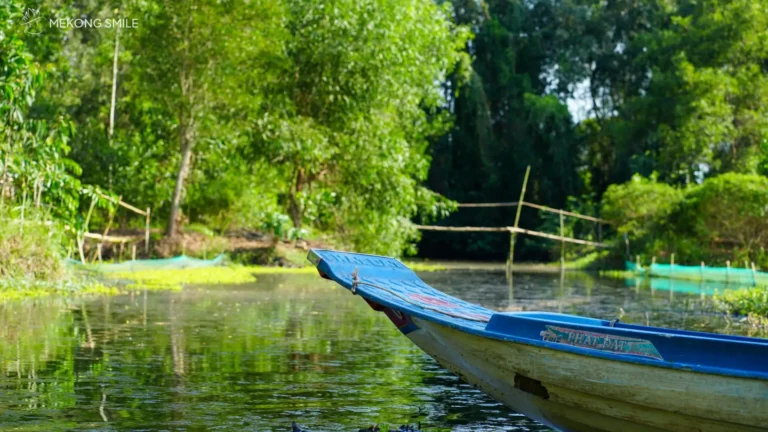 A tour group traveling through the forest on a traditional longboat