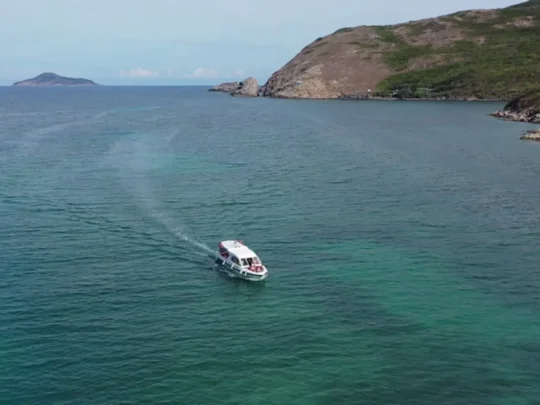 Speedboat cruising across Bamboo Lagoon in Con Dao