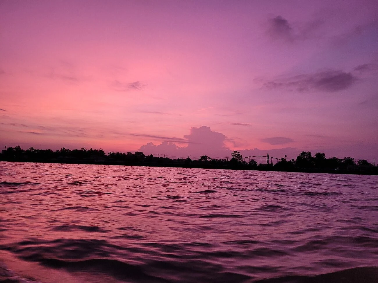 Watching the sunset from boat on the river