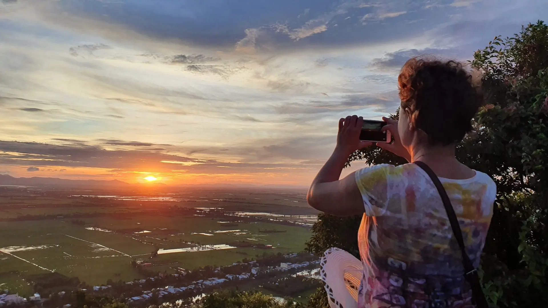 Traveler watching sunset from Sam Mountain near Chau Doc