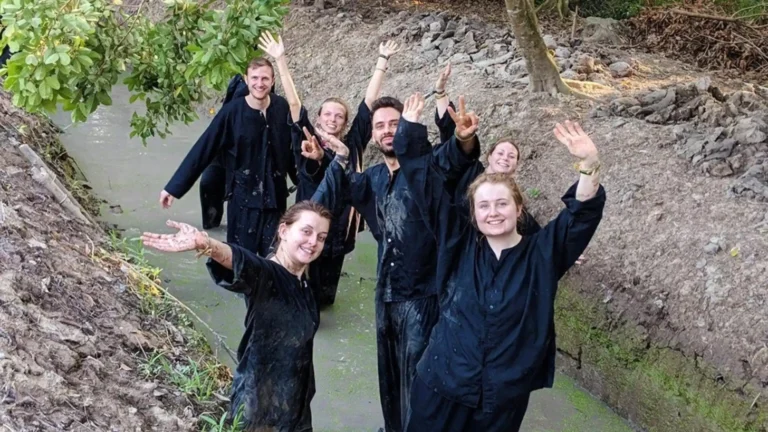Tourists joining Sustainable Tourism activity catching fish in Mekong Delta