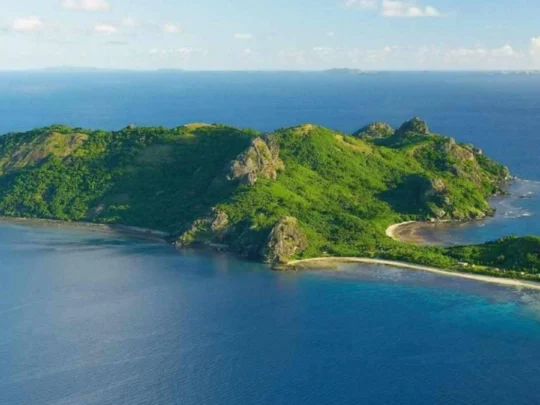 Drone view of Dat Tham Beach tour with clear blue sea and green island scenery in Con Dao