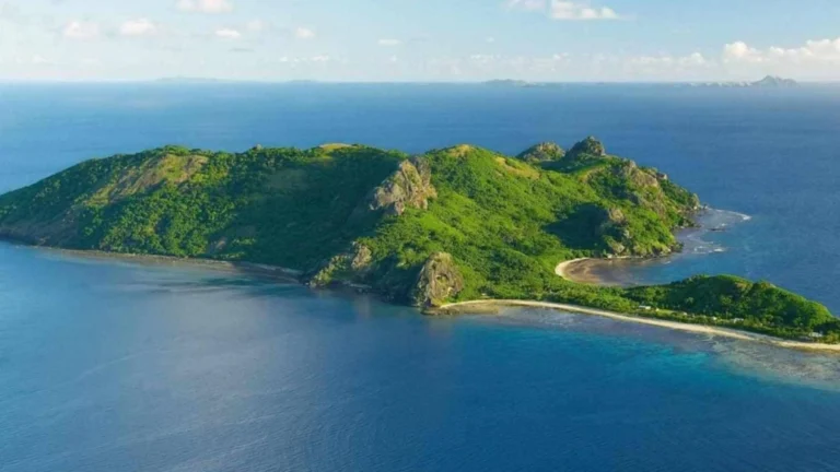 Drone view of Dat Tham Beach tour with clear blue sea and green island scenery in Con Dao