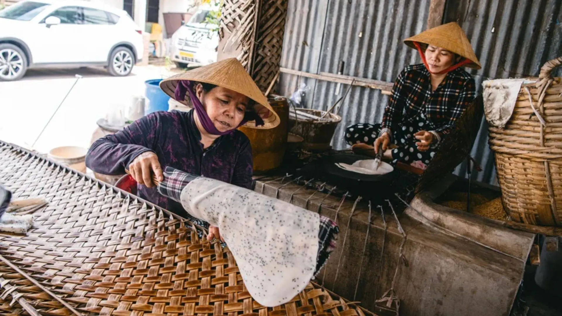 Local artisans shaping rice paper by hand inside Thuan Hung Rice Paper Village