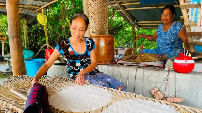 Local women making traditional rice paper by hand at Thuan Hung Rice Paper Village, Can Tho