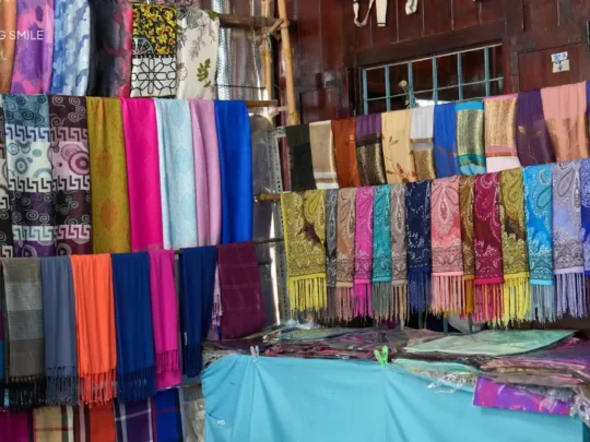 A market area filled with beautiful brocade scarves, a popular souvenir from the Cham village
