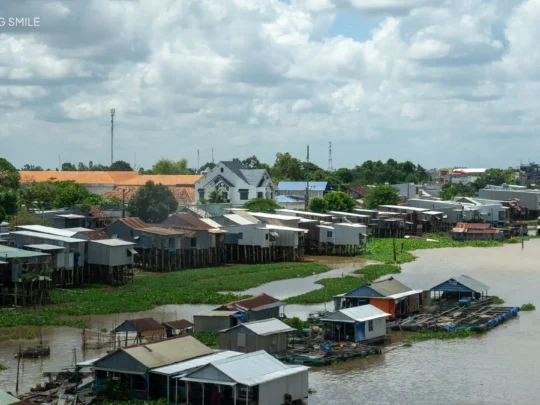 A view of the bustling Chau Doc Floating Village from a cruise boat, showcasing local river life