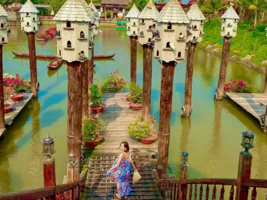 A tourist taking a photo with the special bird nest area, capturing a memorable moment