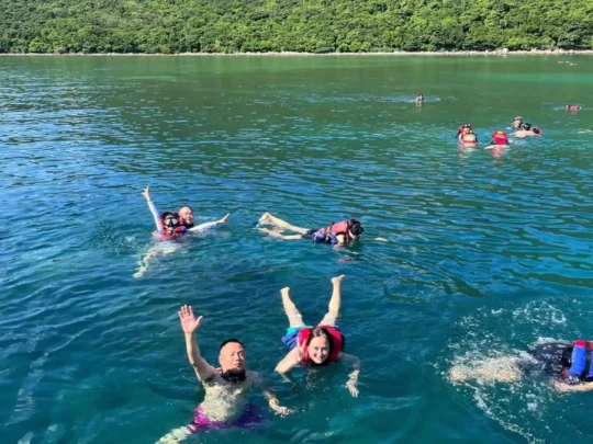 Travelers snorkeling in the clear waters of Bamboo Lagoon in Con Dao