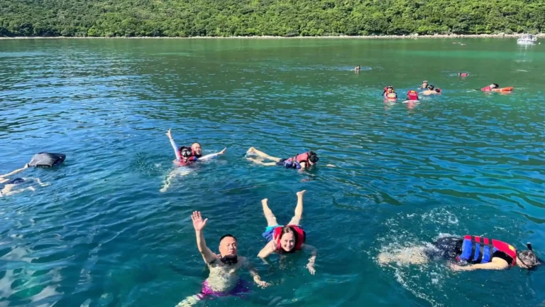 Travelers snorkeling in the clear waters of Bamboo Lagoon in Con Dao