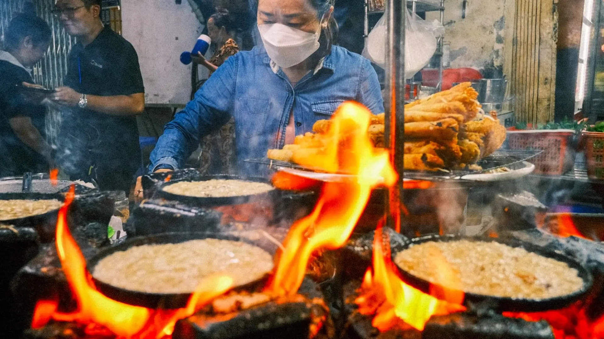 Tourists eating street food in Hanoi night market