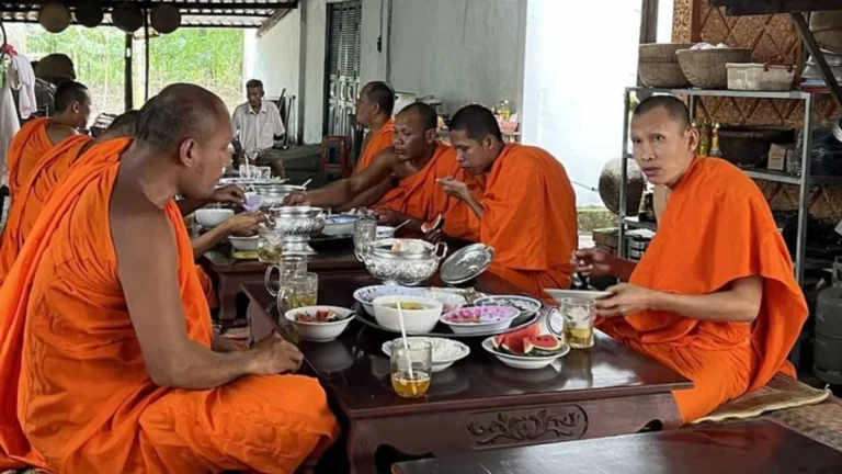 Monks in traditional saffron robes performing a ceremony at Phu Ly Pagoda for guests of the Me Kong Smile tour