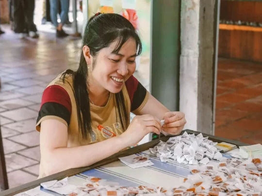 Coconut candy being wrapped by hand at a workshop in Ben Tre