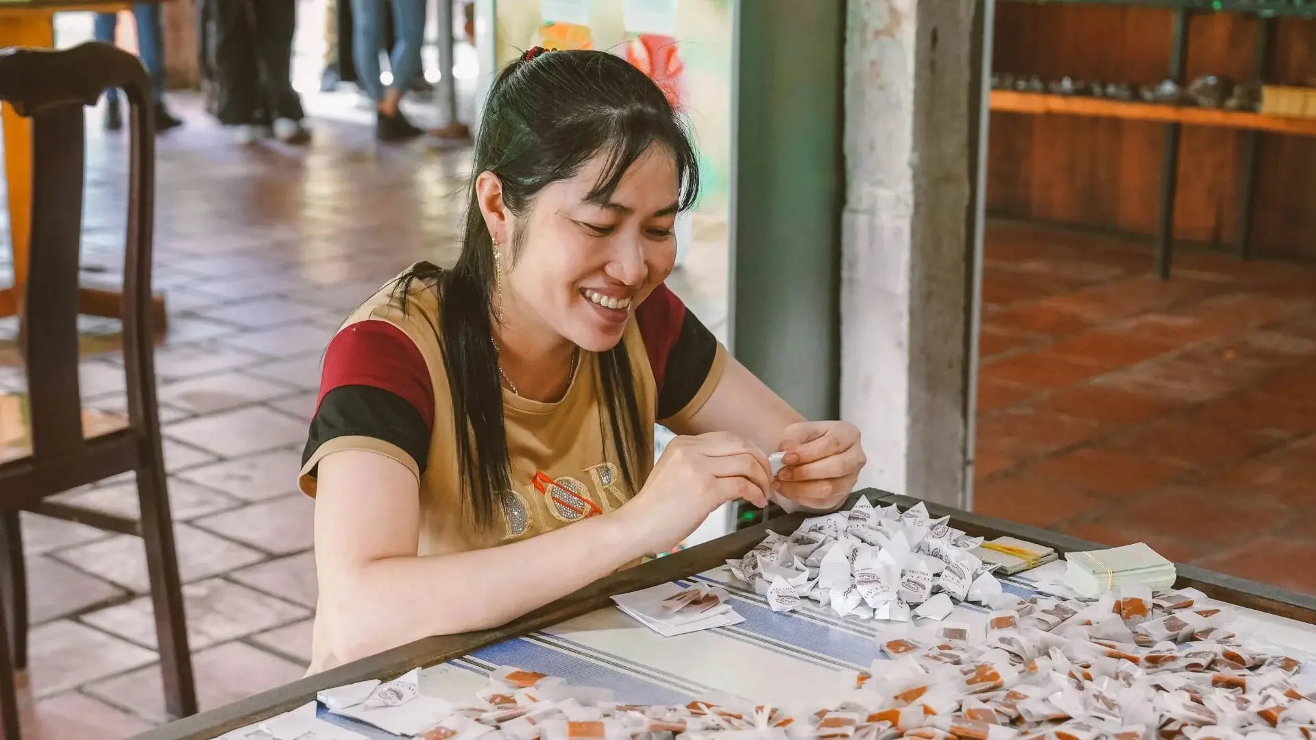 Coconut candy being wrapped by hand at a workshop in Ben Tre